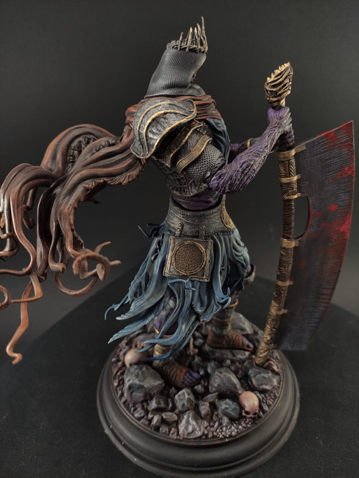 Side angle showing cloak folds, hand positioning, and airbrushed armor