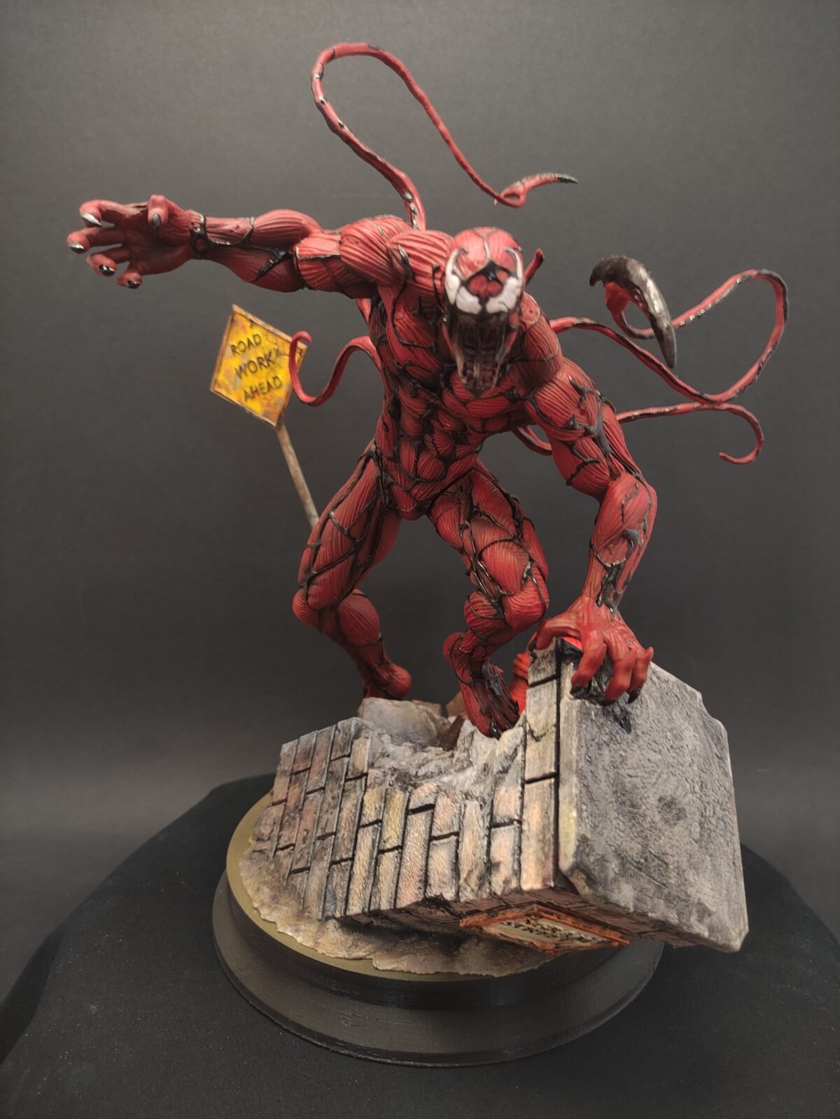 Front-facing view of Carnage statue with exaggerated muscle detail