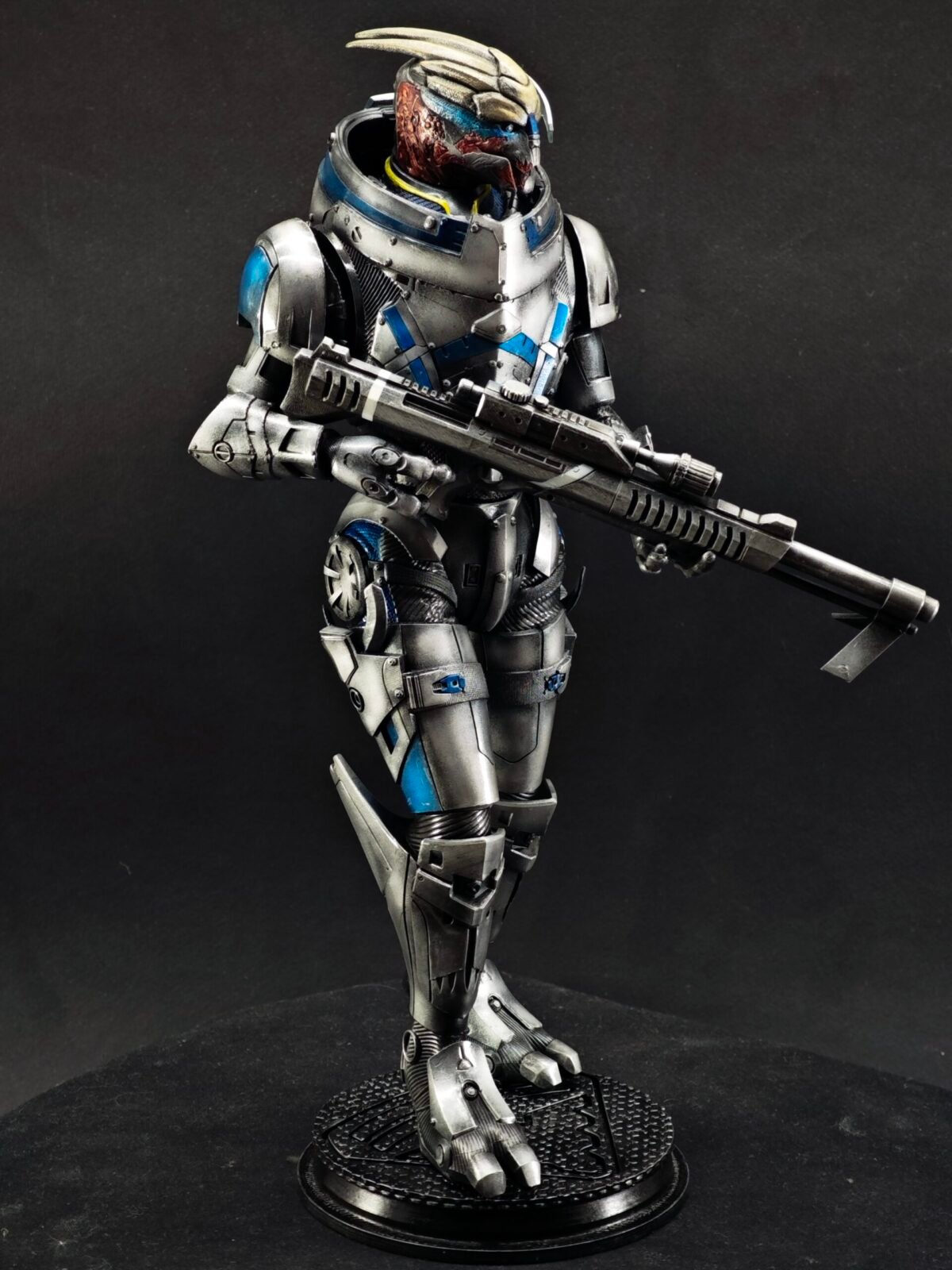 Dynamic side shot showing flowing cloak, boots, and leg armor sculpt