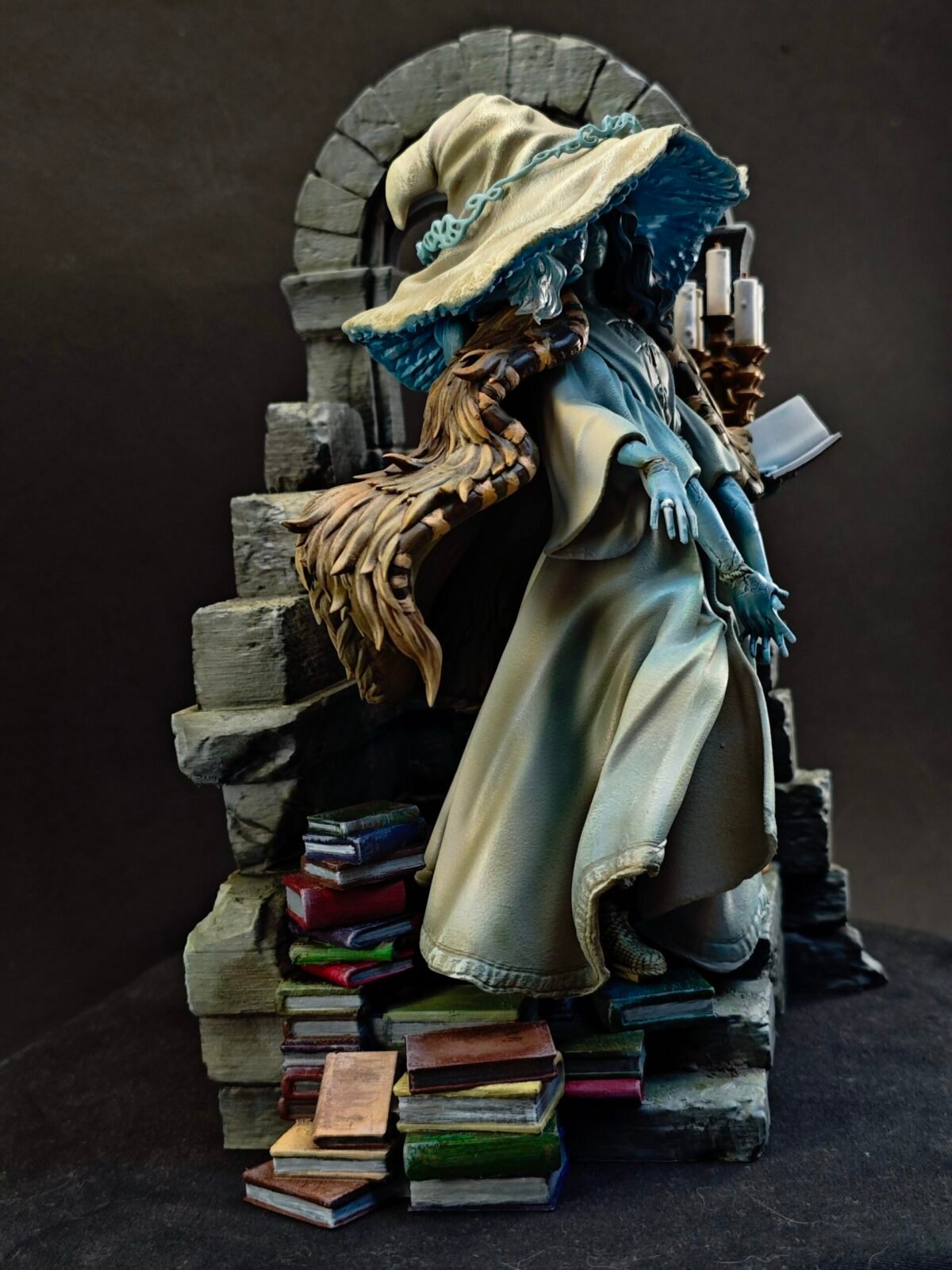 Right-side view of resin figure showing layered fabrics and mystical presence