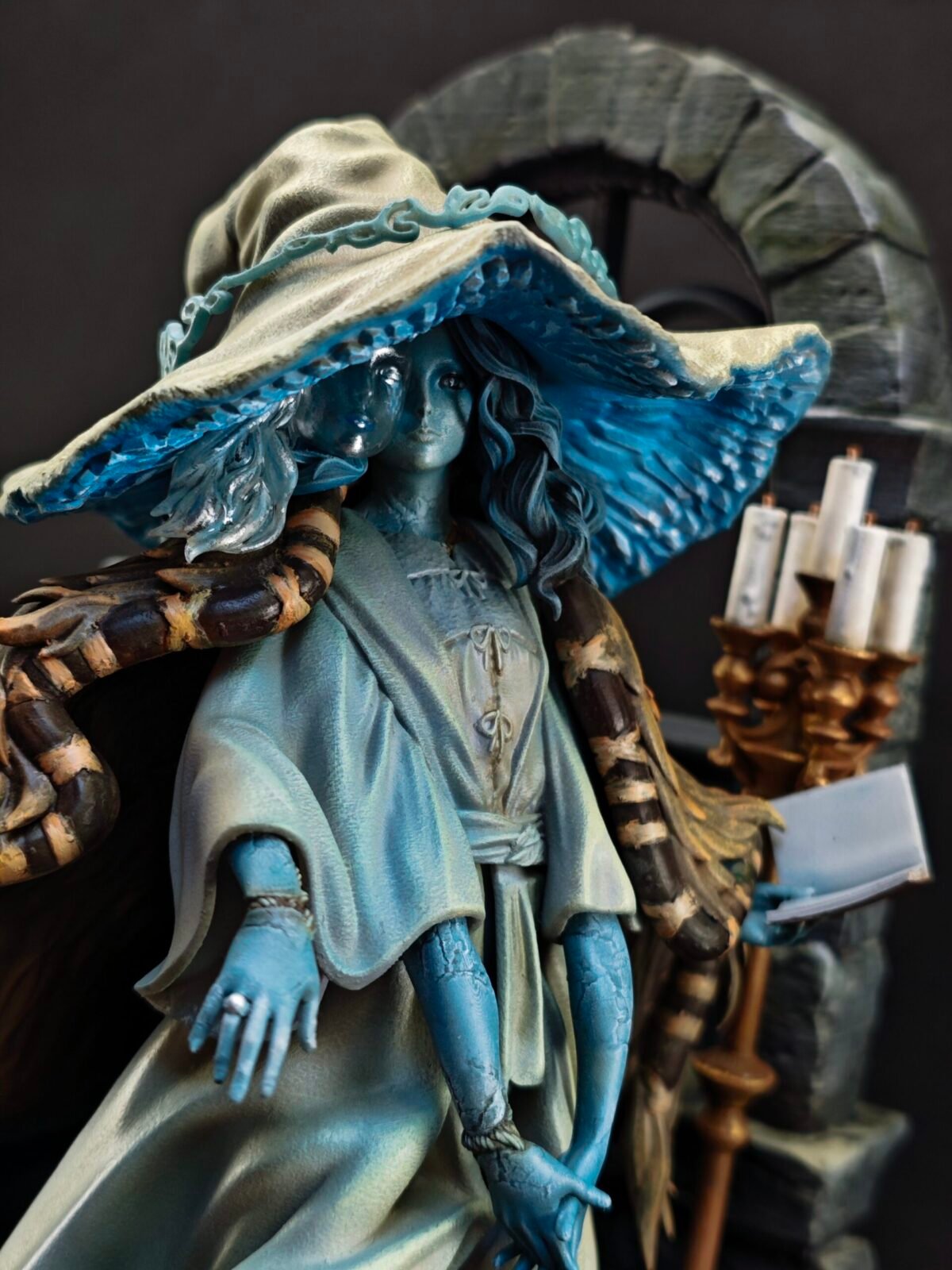Angled front shot showing serene expression and sculpted magical attire