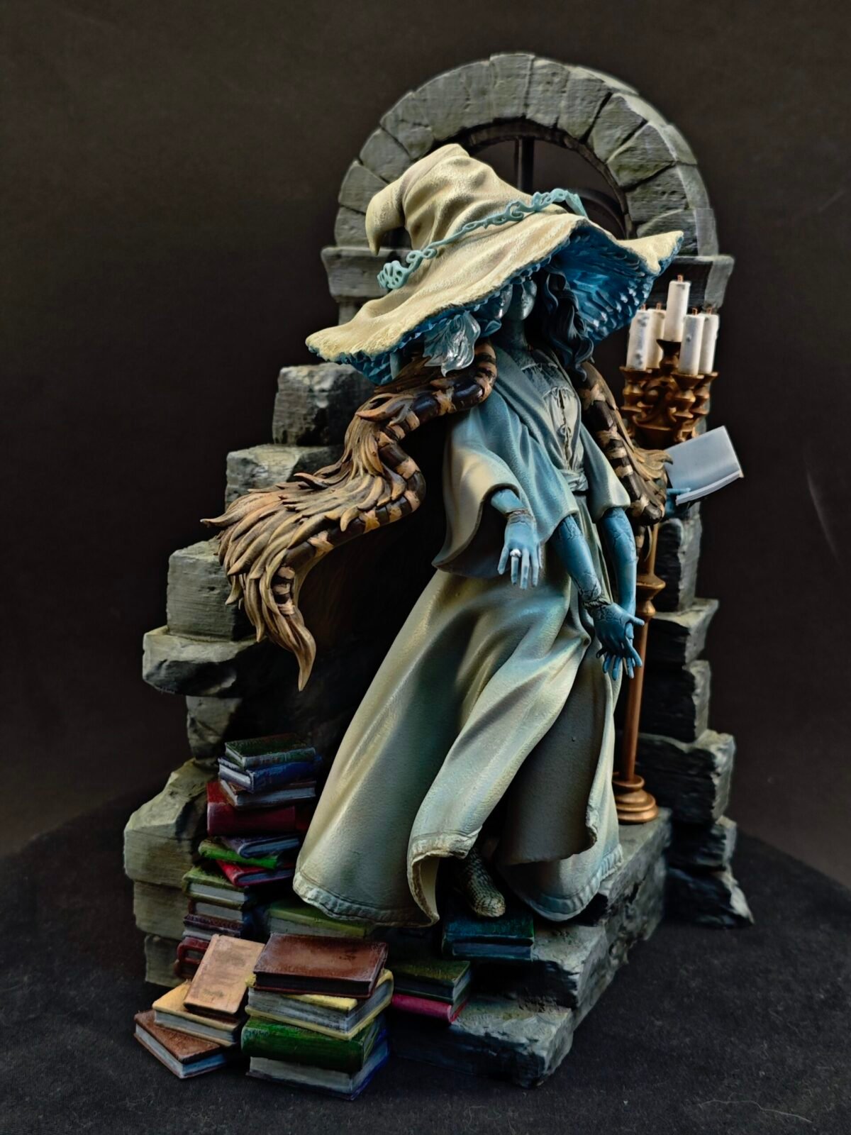 Side view of Ranni the Witch resin figure in wide-brim hat and layered cloak