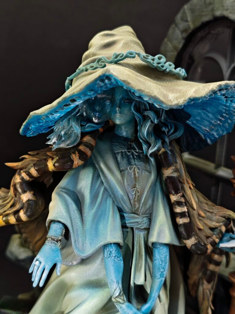 Dynamic view of resin sorceress figure with moonlight glow and hat silhouette