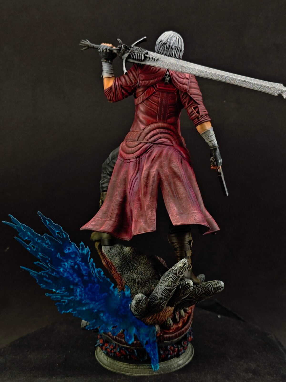 Rear angle highlighting sculpted coat tails and scabbard