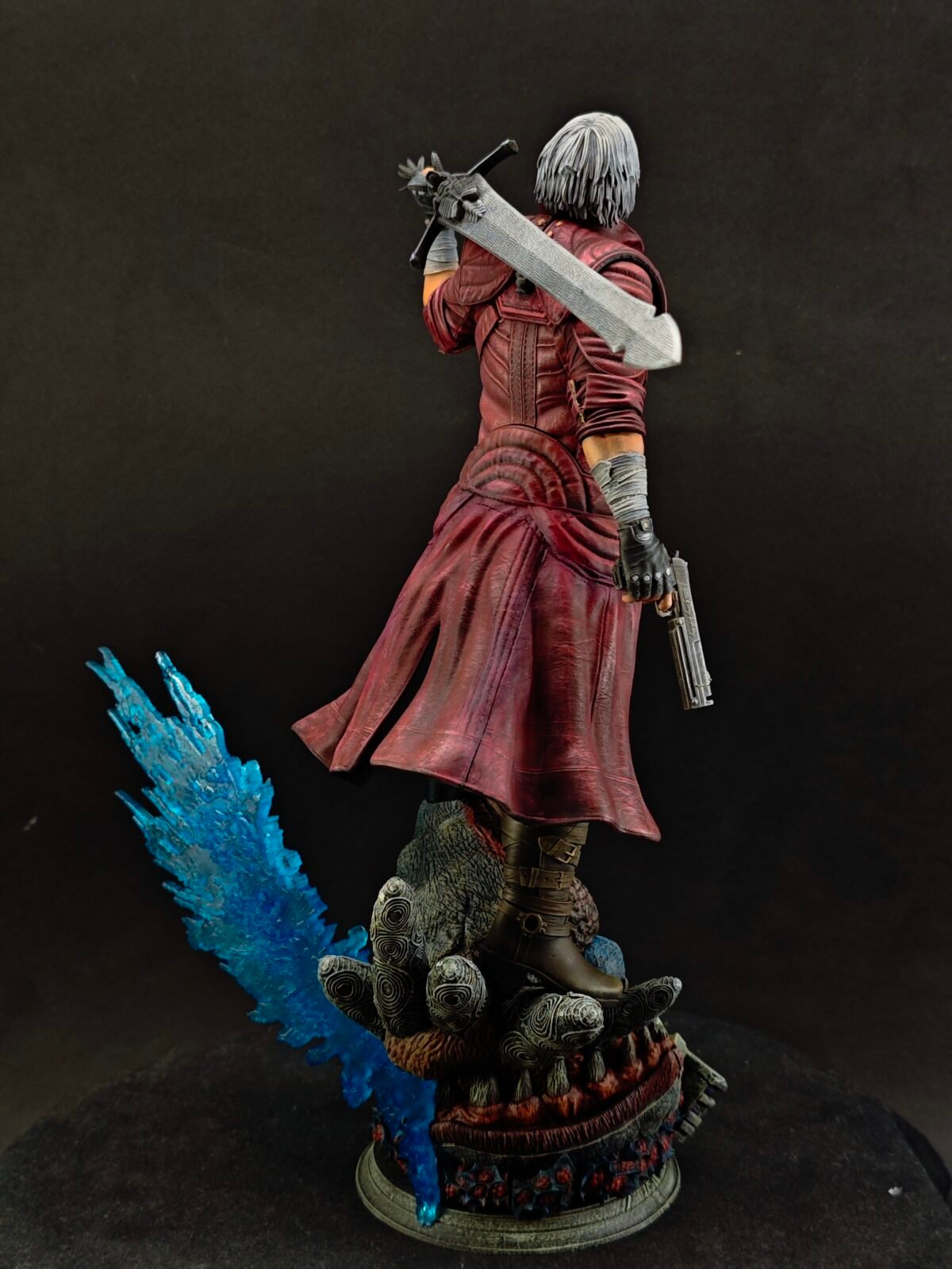 Rear low view capturing hair, sword hilt, and trench flow