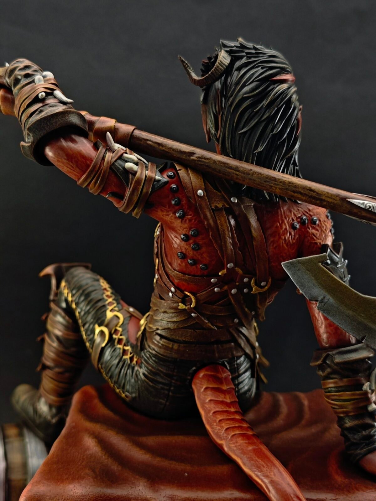 Side view of Karlach with exposed muscle sculpt and weapon detail