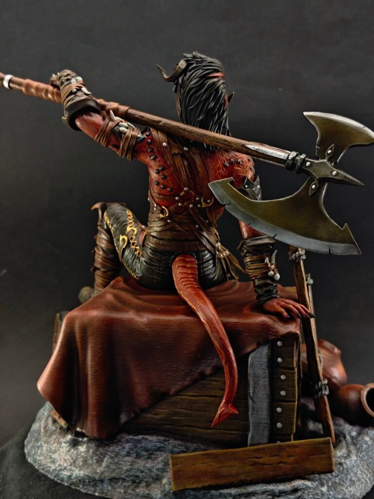 Back view of Karlach highlighting axe handle, cloak edge, and spine sculpt