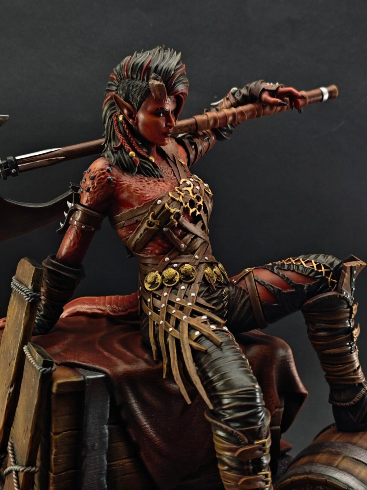 Side view of Karlach resin figure with red armor and dynamic warrior stance