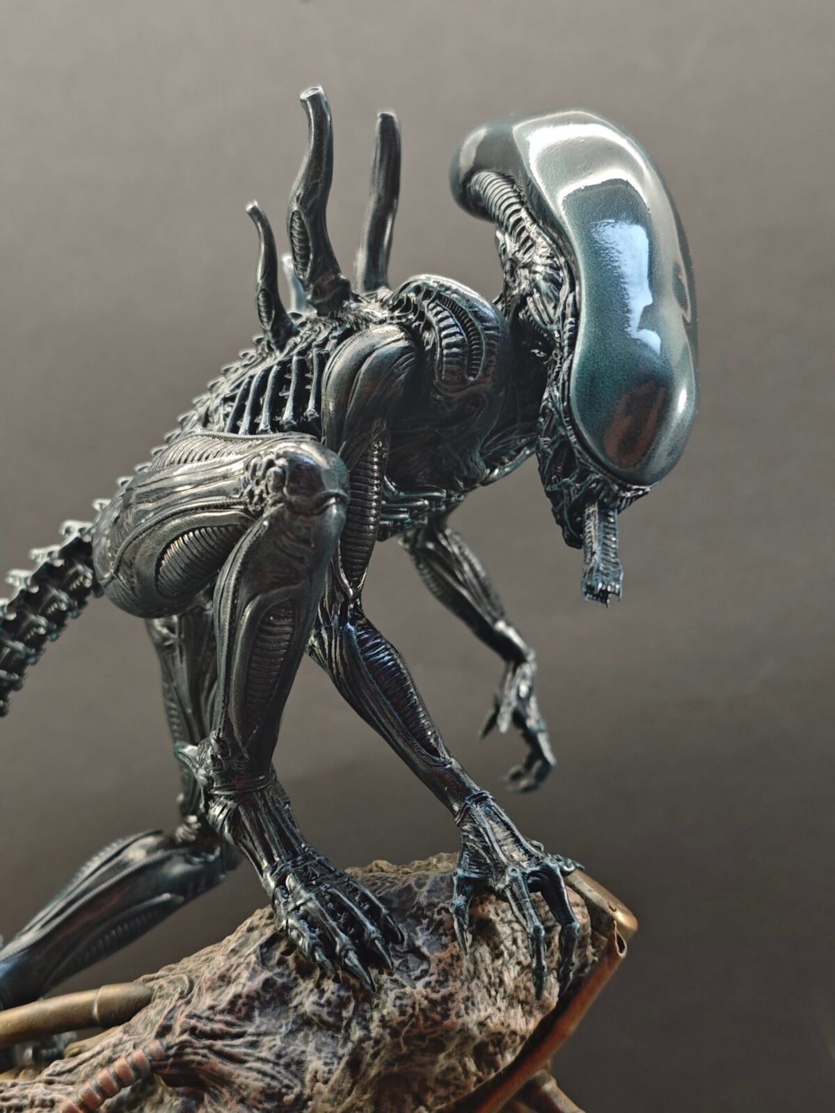 Three-quarter angle of sci-fi horror figure posed on textured display base