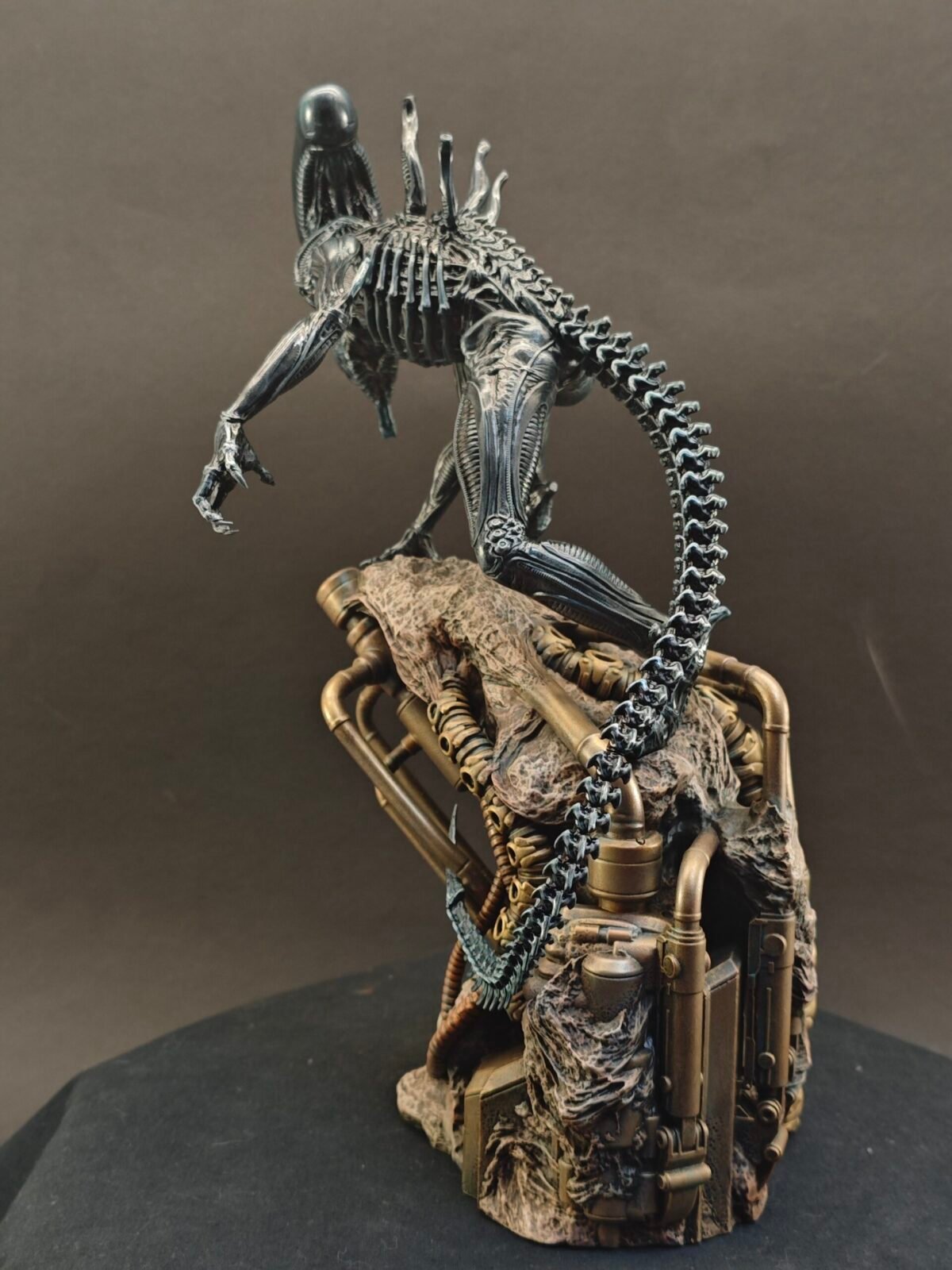 Side view of Xenomorph resin figure with elongated head and sculpted tail in motion