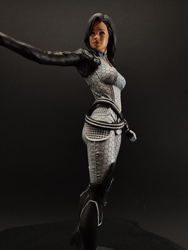 Right-side view of Miranda figure with hand on hip and steady posture