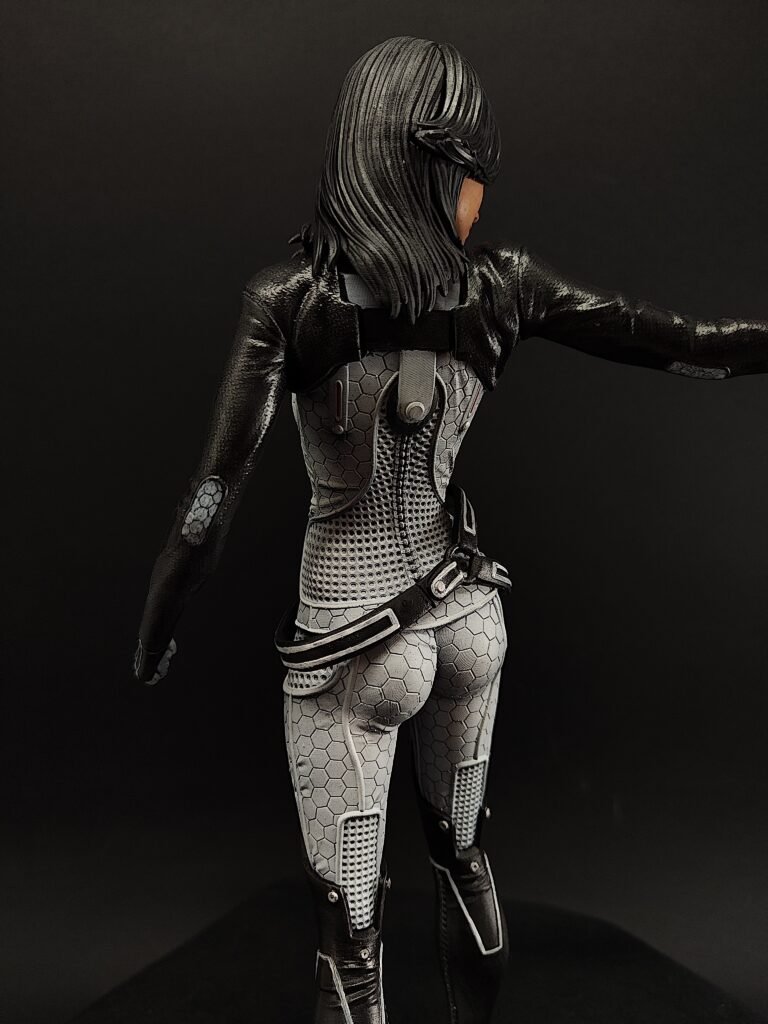 Back view showing sculpted suit lines and flowing hair from shoulder