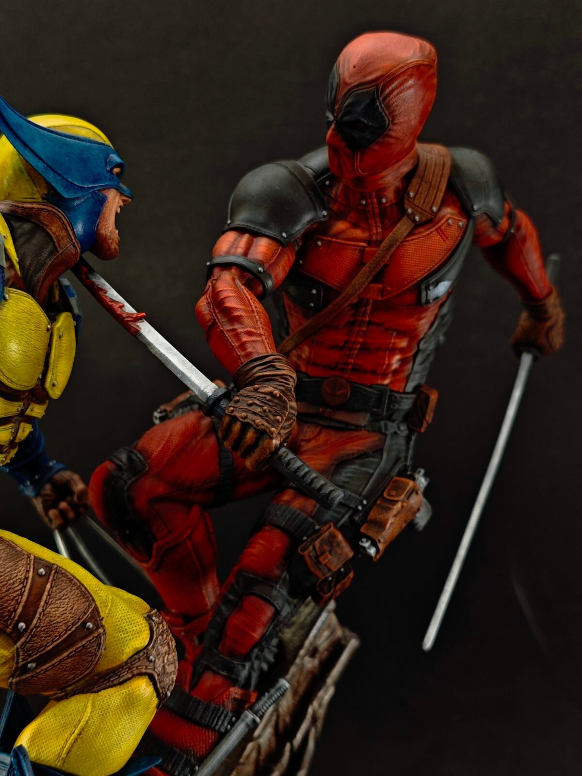 Dynamic angle showing mid-battle pose between two comic-inspired resin characters