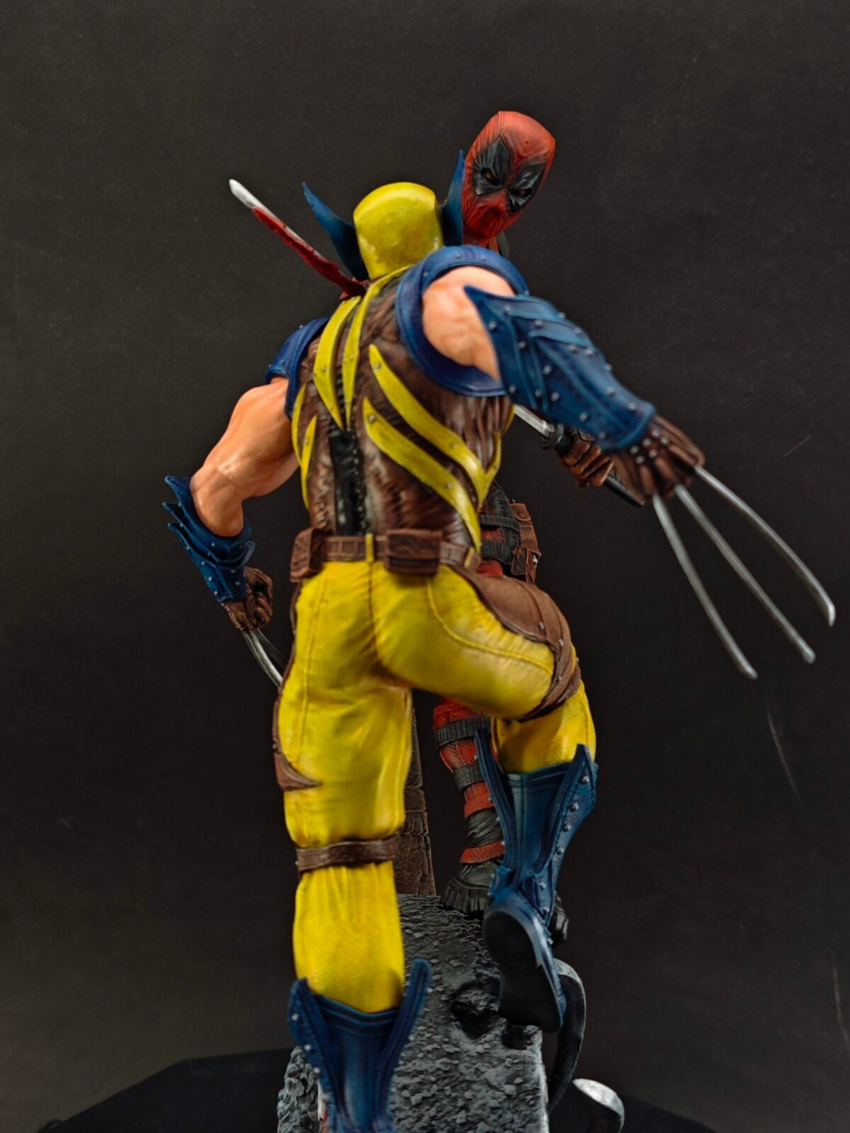 Back view showing flowing costume details and cracked terrain base