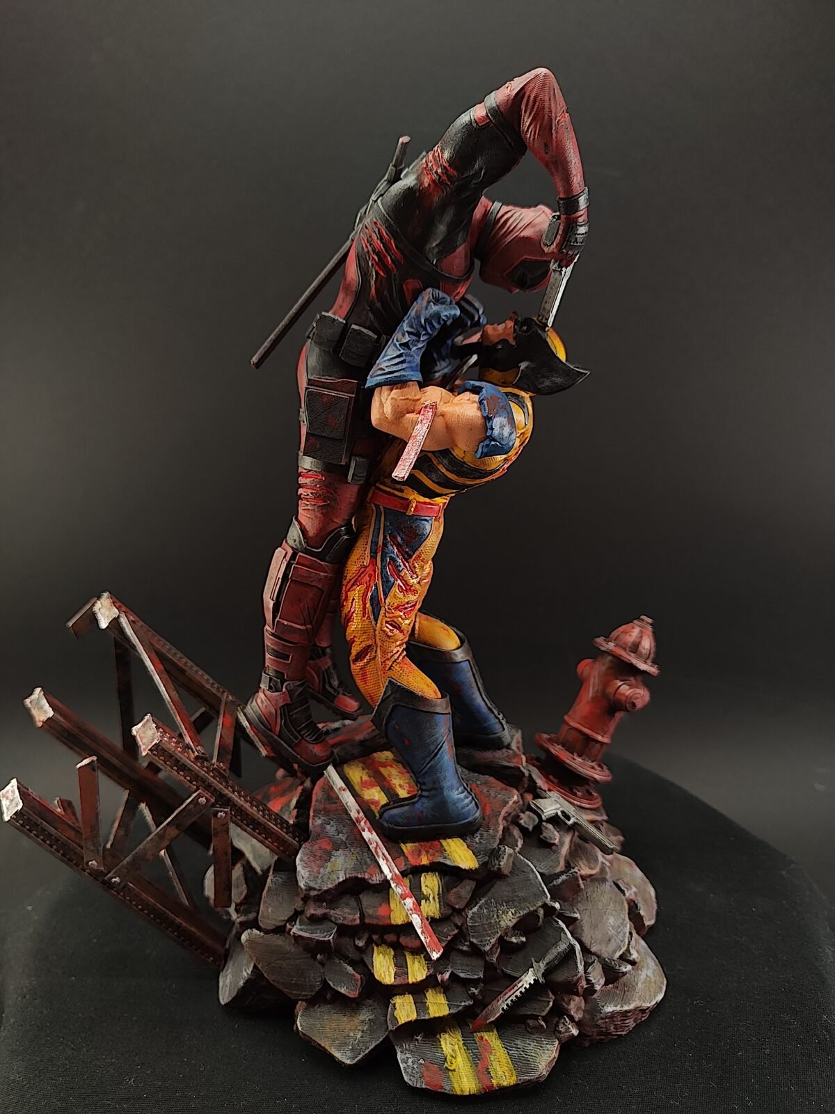 Hand-painted Deadpool vs Wolverine resin figure in dynamic battle pose