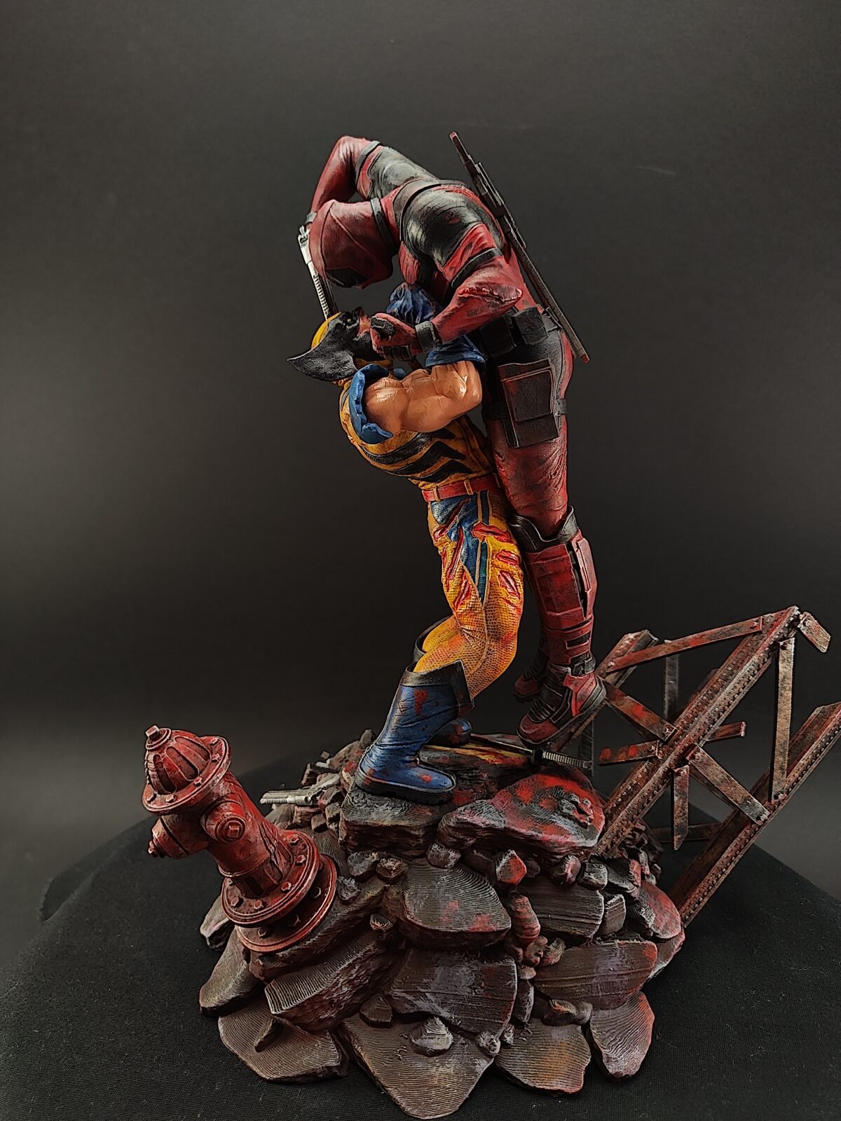 Front-facing image of Deadpool vs Wolverine custom painted statue